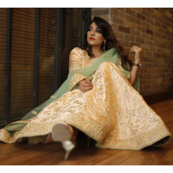 A Pastel Peach Embroidered Lehenga Set with English Elms Green Net Dupatta