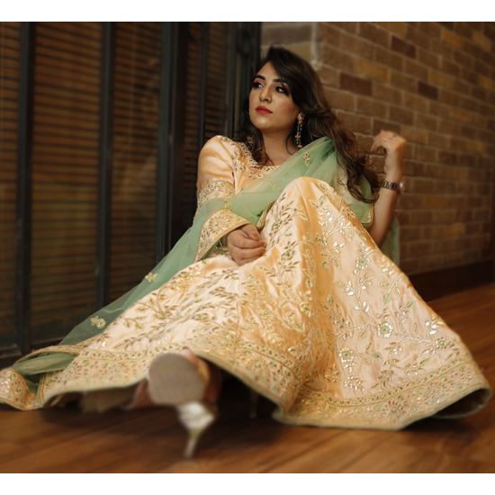 A Pastel Peach Embroidered Lehenga Set with English Elms Green Net Dupatta